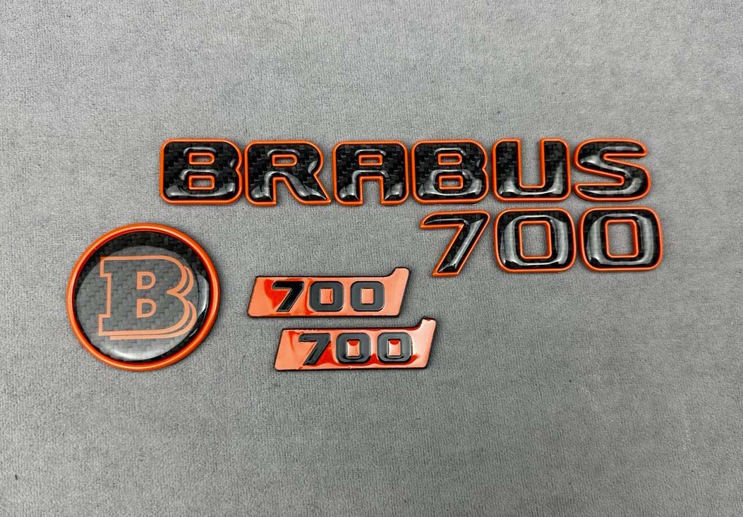 Brabus 700 Carbon badges set in orange color